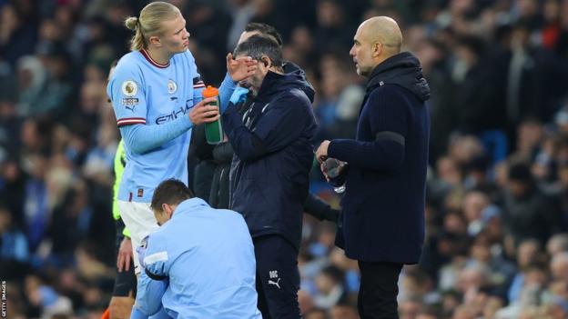 Erling Haaland (à gauche) s'entretient avec le manager de Manchester City, Pep Guardiola (à droite)